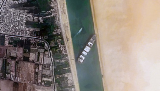 The Ever Given lodged in the Suez Canal. Image: Pierre Markuse/Wikimedia Commons Image:The Ever Given lodged in the Suez Canal. Image: Pierre Markuse/Wikimedia Commons