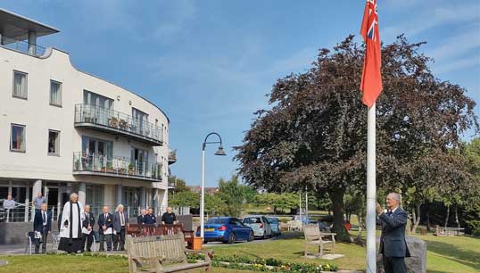 Mariners' Park resident Captain Alex Harrison helped hoist the Red Ensign during the ceremony. Images: Nautilus International Image:Mariners' Park resident Captain Alex Harrison helped hoist the Red Ensign during the ceremony. Images: Nautilus International